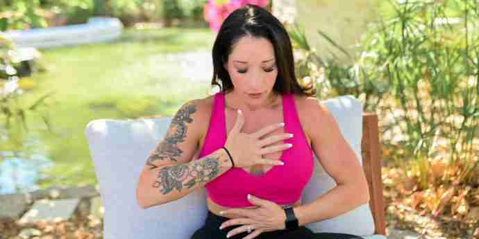 Karissa doing breathwork outside, hands on chest looking for her balance. Rediscovering Self-Love: The Path to a Happier and Healthier You in 2024